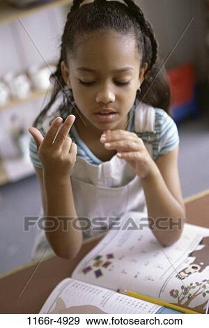 Stock Photo - Girl counting on her fingers. Fotosearch