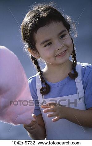 Stock Image - Girl holding cotton candy. Fotosearch