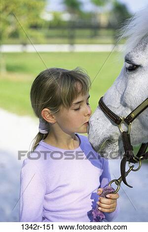 Girl kissing a horse View Large Photo Image Stock Image - Girl kissing a horse. Fotosearch