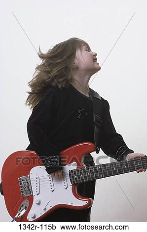 Stock Image - Girl playing an electric guitar. Fotosearch