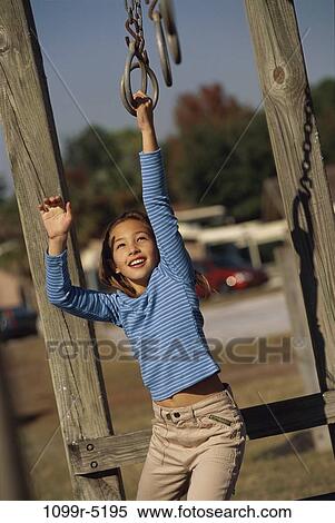 Girl playing on a jungle gym View Large Photo Image Stock Photography - Girl playing on a jungle gym. Fotosearch
