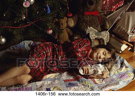 Girl sleeping while holding a toy View Large Photo Image Stock Photograph - Girl sleeping while holding a toy. Fotosearch