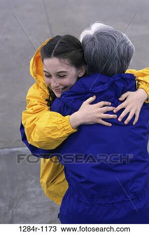 Granddaughter hugging her grandmother View Large Photo Image Stock Image - Granddaughter hugging her grandmother. Fotosearch