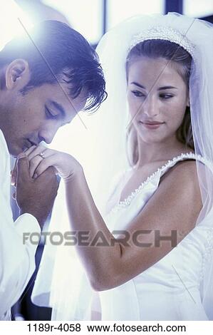 Groom kissing his brides hand View Large Photo Image Stock Photo - Groom kissing his brides hand. Fotosearch