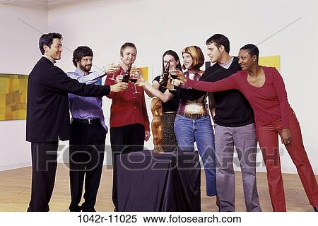 Group of people toasting in an art gallery View Large Photo Image Stock Photography - Group of people toasting in an art gallery. Fotosearch