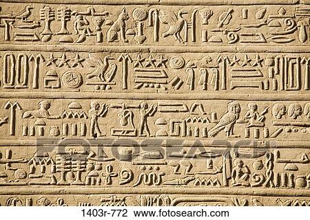 Stock Image - Hieroglyphics carved into a wall of the Temple of Horus and Sobek at the ancient ruins of Kom Ombo on the Nile River in southern Egypt. Fotosearch