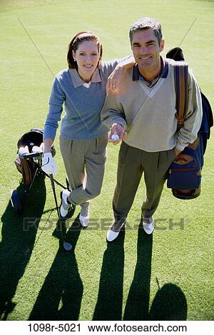 High angle view of a mid adult couple on a golf course View Large Photo Image Stock Image - High angle view of a mid adult couple on a golf course. Fotosearch