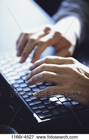 High angle view of a person's hand operating a computer keyboard View Large Photo Image Stock Photo - High angle view of a person's hand operating a computer keyboard. Fotosearch
