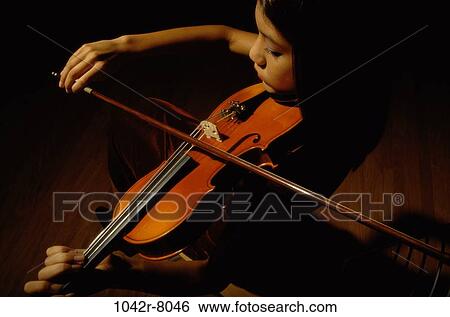 High angle view of a young woman playing the violin View Large Photo Image Stock Photograph - High angle view of a young woman playing the violin. Fotosearch