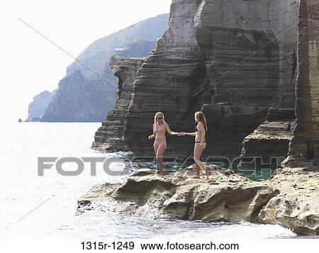 Italy, Campania, Ischia Island, Mother and daughter exchanging suntan lotion View Large Photo Image Stock Photo - Italy, Campania, Ischia Island, Mother and daughter exchanging suntan lotion. Fotosearch