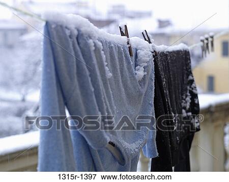 Italy, clothes hanging from clothes line during snowy weather View Large Photo Image Stock Photo - Italy, clothes hanging from clothes line during snowy weather. Fotosearch