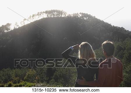 Italy, Liguria, Cinque Terre, Monterosso al Mare, Couple looking at forested hillside View Large Photo Image Stock Photography - Italy, Liguria, Cinque Terre, Monterosso al Mare, Couple looking at forested hillside. Fotosearch