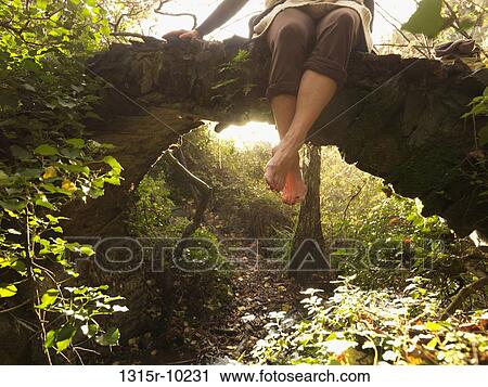 Italy, Liguria, Cinque Terre, Vernazza, Woman's legs dangling from stone bridge on trail View Large Photo Image Stock Image - Italy, Liguria, Cinque Terre, Vernazza, Woman's legs dangling from stone bridge on trail. Fotosearch