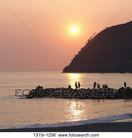 Italy, Liguria, Levanto, People fishing and standing on rock breakwater View Large Photo Image Stock Photograph - Italy, Liguria, Levanto, People fishing and standing on rock breakwater. Fotosearch