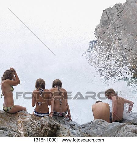 Italy, Liguria, Teenagers brace themselves against ocean surf View Large Photo Image Stock Image - Italy, Liguria, Teenagers brace themselves against ocean surf. Fotosearch