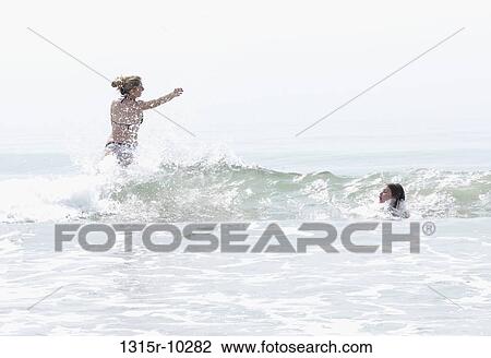Italy, Mediterranean, Teenage girls play in ocean surf View Large Photo Image Stock Image - Italy, Mediterranean, Teenage girls play in ocean surf. Fotosearch