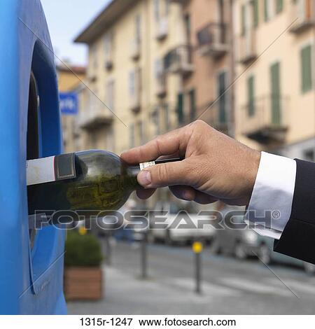 Italy, Piedmont, Businessman dropping bottle into recycling bin View Large Photo Image Stock Photo - Italy, Piedmont, Businessman dropping bottle into recycling bin. Fotosearch