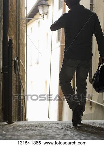 Italy, Piedmont, Businessman walking through historic corridor View Large Photo Image Stock Photography - Italy, Piedmont, Businessman walking through historic corridor. Fotosearch
