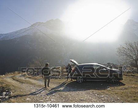 Italy, Piedmont, Couple leaving car to begin hike in mountains View Large Photo Image Stock Image - Italy, Piedmont, Couple leaving car to begin hike in mountains. Fotosearch