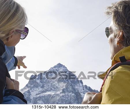 Italy, Piedmont, Couple looking out to distant mountain summit View Large Photo Image Stock Photo - Italy, Piedmont, Couple looking out to distant mountain summit. Fotosearch