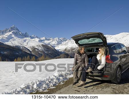 Italy, Piedmont, Couple resting in back of car on mountain road View Large Photo Image Stock Image - Italy, Piedmont, Couple resting in back of car on mountain road. Fotosearch