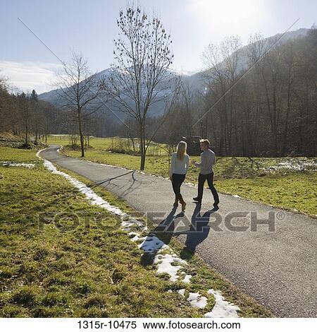 Italy, Piedmont, Couple walking along mountain road View Large Photo Image Stock Photography - Italy, Piedmont, Couple walking along mountain road. Fotosearch