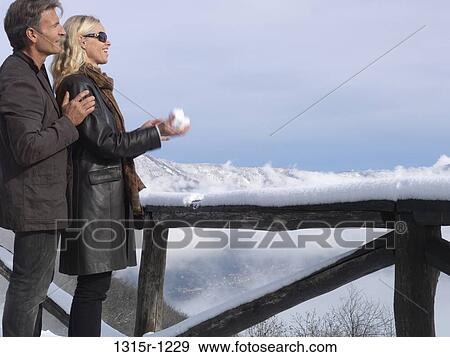 Italy, Piedmont, Couple watching view, woman making snowball View Large Photo Image Stock Photo - Italy, Piedmont, Couple watching view, woman making snowball. Fotosearch