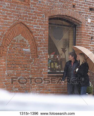 Italy, Piedmont, couple window shopping in snowstorm View Large Photo Image Stock Photograph - Italy, Piedmont, couple window shopping in snowstorm. Fotosearch