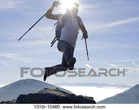 Italy, Piedmont, Hiker jumping from rock above mountains View Large Photo Image Stock Image - Italy, Piedmont, Hiker jumping from rock above mountains. Fotosearch