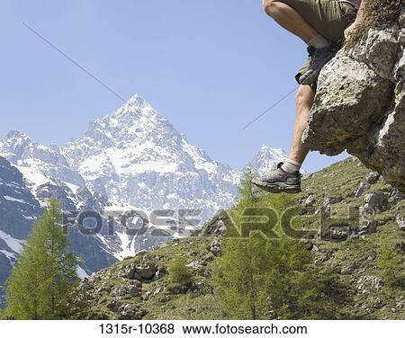 Italy, Piedmont, Hiker sitting on rock on Monte Viso, low section View Large Photo Image Stock Photo - Italy, Piedmont, Hiker sitting on rock on Monte Viso, low section. Fotosearch