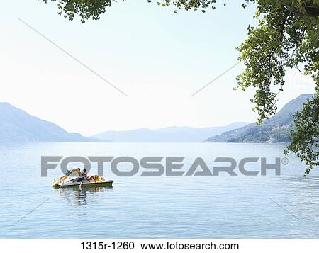 Italy, Piedmont, Lake Maggiore, Family steering paddleboat View Large Photo Image Stock Image - Italy, Piedmont, Lake Maggiore, Family steering paddleboat. Fotosearch