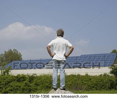 Italy, Piedmont, man looking at solar panels View Large Photo Image Stock Photograph - Italy, Piedmont, man looking at solar panels. Fotosearch