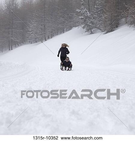 Italy, Piedmont, Mom running after kids tobogganing View Large Photo Image Stock Image - Italy, Piedmont, Mom running after kids tobogganing. Fotosearch