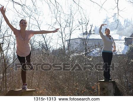 Italy, Piedmont, mother and daughter pretending to be statues on gateposts View Large Photo Image Stock Image - Italy, Piedmont, mother and daughter pretending to be statues on gateposts. Fotosearch