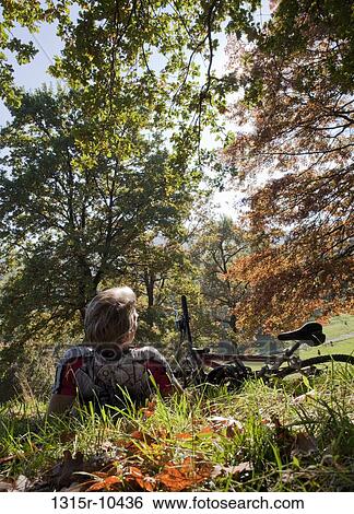 Italy, Piedmont, Mountain biker resting in park View Large Photo Image Stock Photograph - Italy, Piedmont, Mountain biker resting in park. Fotosearch