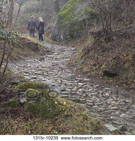 Italy, Piedmont, Sacra di San Michele, Couple walking up cobblestone path View Large Photo Image Stock Photo - Italy, Piedmont, Sacra di San Michele, Couple walking up cobblestone path. Fotosearch