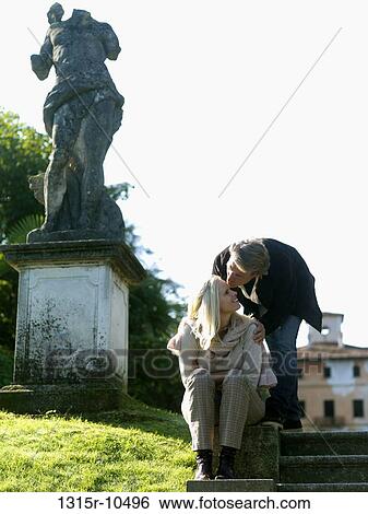 Italy, Piedmont, Stresa, Lake Maggiore, Couple kissing beside headless statue View Large Photo Image Stock Photograph - Italy, Piedmont, Stresa, Lake Maggiore, Couple kissing beside headless statue. Fotosearch