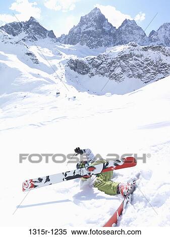 Italy, Piedmont, Teenage boy falling while skiing down mountain slope View Large Photo Image Stock Photography - Italy, Piedmont, Teenage boy falling while skiing down mountain slope. Fotosearch