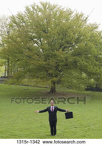Italy, Piedmont, Turin, businessman standing in park with outstretched arms View Large Photo Image Stock Image - Italy, Piedmont, Turin, businessman standing in park with outstretched arms. Fotosearch