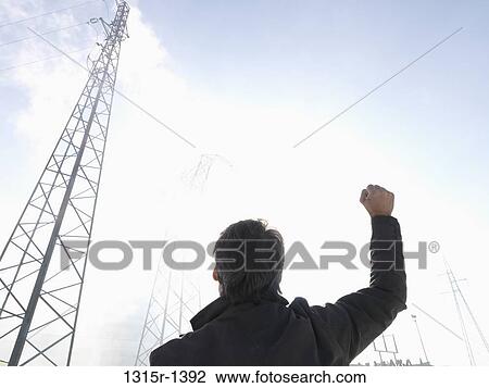 Italy, Piedmont, Turin, businessman raising fist in air below power lines View Large Photo Image Stock Image - Italy, Piedmont, Turin, businessman raising fist in air below power lines. Fotosearch