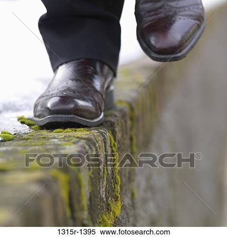 Italy, Piedmont, Turin, businessman's feet traversing icy and mossy ledge View Large Photo Image Stock Photography - Italy, Piedmont, Turin, businessman's feet traversing icy and mossy ledge. Fotosearch