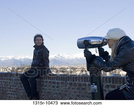 Italy, Piedmont, Turin, Couple looking through spotting telescope View Large Photo Image Stock Image - Italy, Piedmont, Turin, Couple looking through spotting telescope. Fotosearch