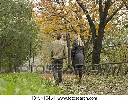 Italy, Piedmont, Turin, Couple walking along autumn path in city View Large Photo Image Stock Image - Italy, Piedmont, Turin, Couple walking along autumn path in city. Fotosearch