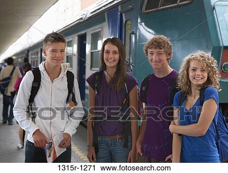 Italy, Piedmont, Turin, Four teenagers waiting with tickets in hand, at train station View Large Photo Image Stock Image - Italy, Piedmont, Turin, Four teenagers waiting with tickets in hand, at train station. Fotosearch
