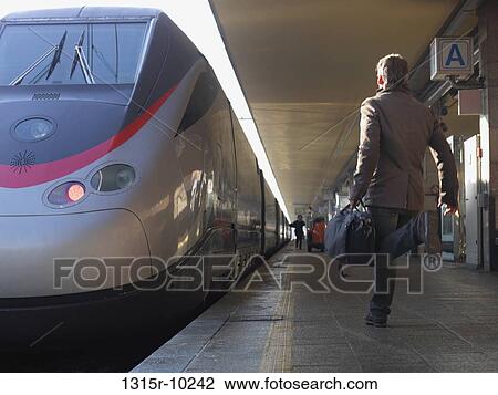 Italy, Piedmont, Turin, Man approaching Eurostar high speed train View Large Photo Image Stock Image - Italy, Piedmont, Turin, Man approaching Eurostar high speed train. Fotosearch