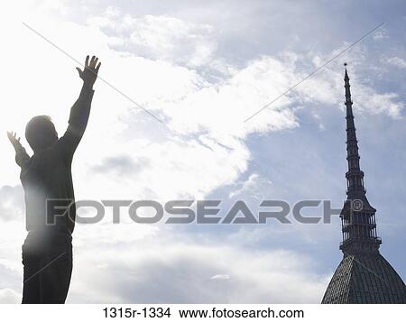 Italy, Piedmont, Turin, Man raising arms facing Mole View Large Photo Image Picture - Italy, Piedmont, Turin, Man raising arms facing Mole. Fotosearch