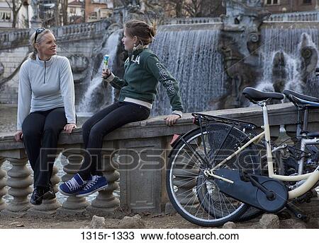 Italy, Piedmont, Turin, mother and daughter sitting by fountain View Large Photo Image Stock Image - Italy, Piedmont, Turin, mother and daughter sitting by fountain. Fotosearch