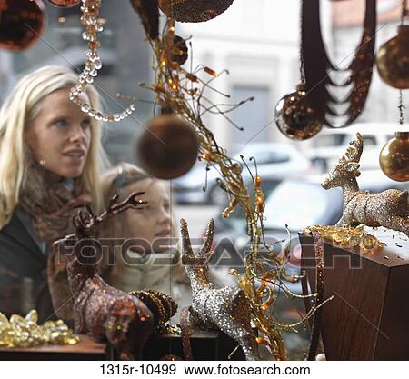 Italy, Piedmont, Turin, Mother and daughter looking at Christmas ornaments in shop window View Large Photo Image Stock Photo - Italy, Piedmont, Turin, Mother and daughter looking at Christmas ornaments in shop window. Fotosearch