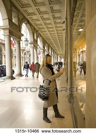 Italy, Piedmont, Turin, Woman taking picture in storefront window View Large Photo Image Stock Photograph - Italy, Piedmont, Turin, Woman taking picture in storefront window. Fotosearch