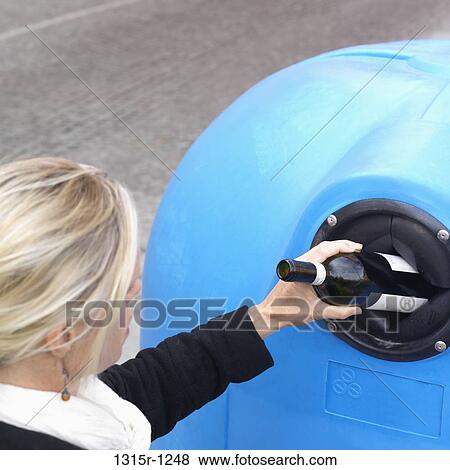 Italy, Piedmont, Woman dropping bottle into recycling bin View Large Photo Image Stock Photo - Italy, Piedmont, Woman dropping bottle into recycling bin. Fotosearch